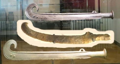 Bronze sword with curved blade 
and stone copy